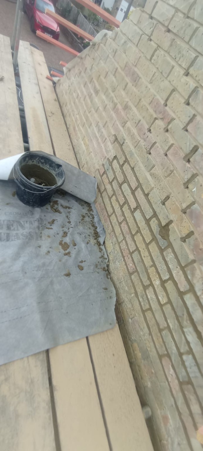 Brick wall repointing next to a flat roof in Tadley, Hampshire
