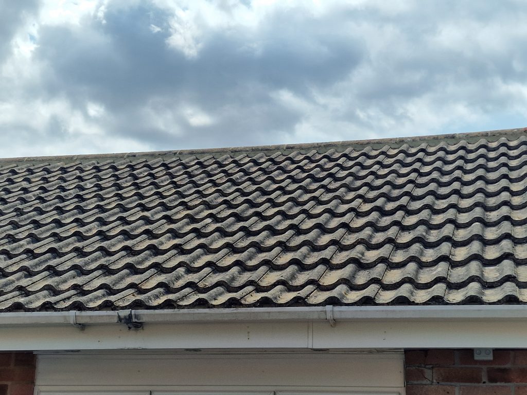 Clear gutter under a cleaned tile roof in Hampshire