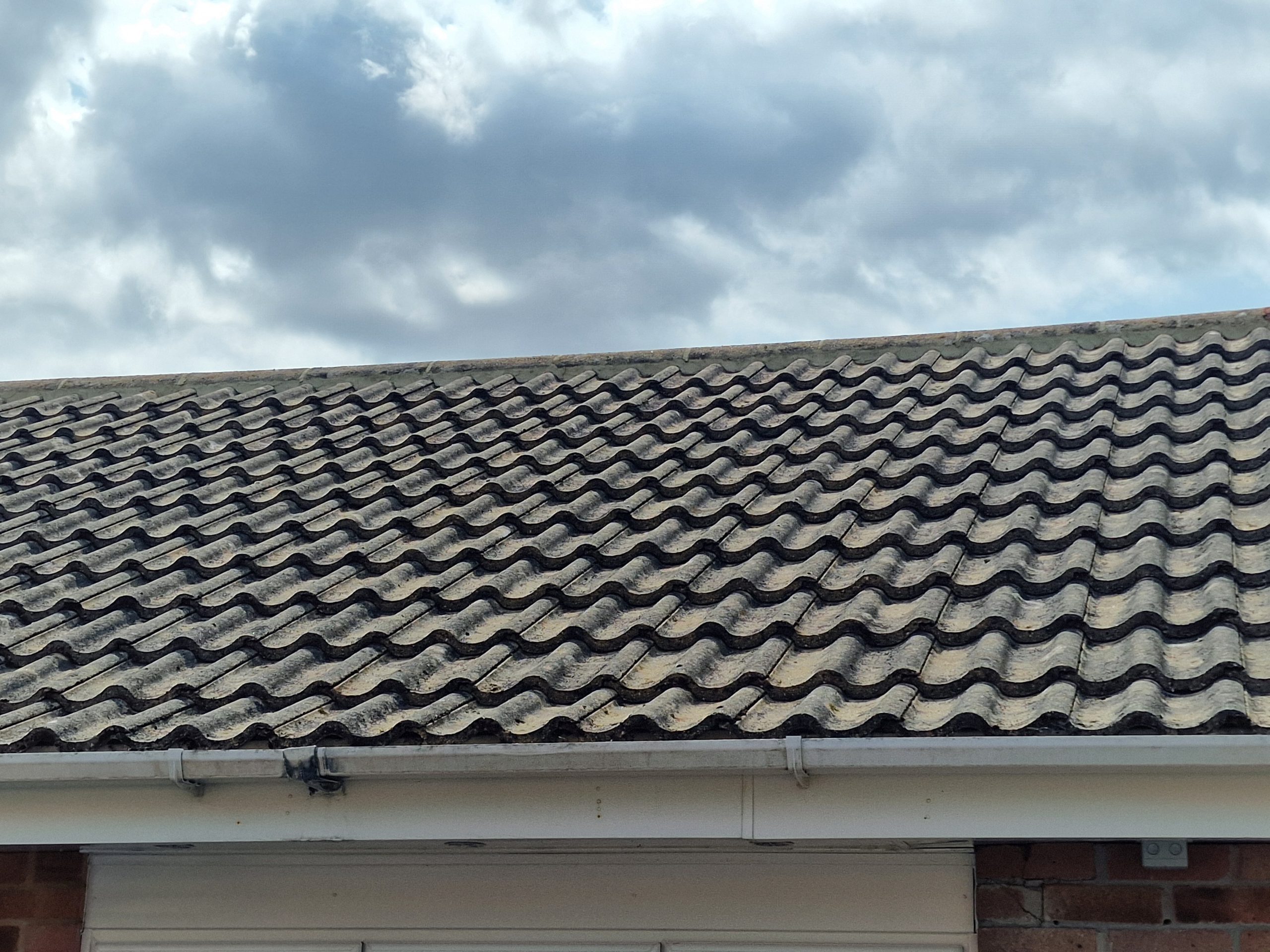 Clear white gutter under a cleaned concrete tile roof in Hampshire