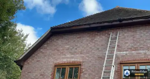 Fascia and barge boards sanded and painted with two coats on a brick gable in Little London, near Tadley