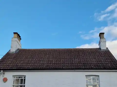 The same cottage roof after moss removal by hand