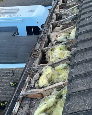 Edge of a roof opened up to check the timber underneath, near Basingstoke